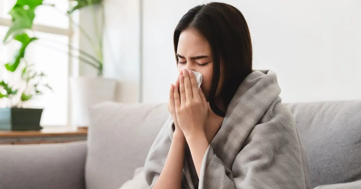 A woman is having the flu and she is following the tips to beat the flu