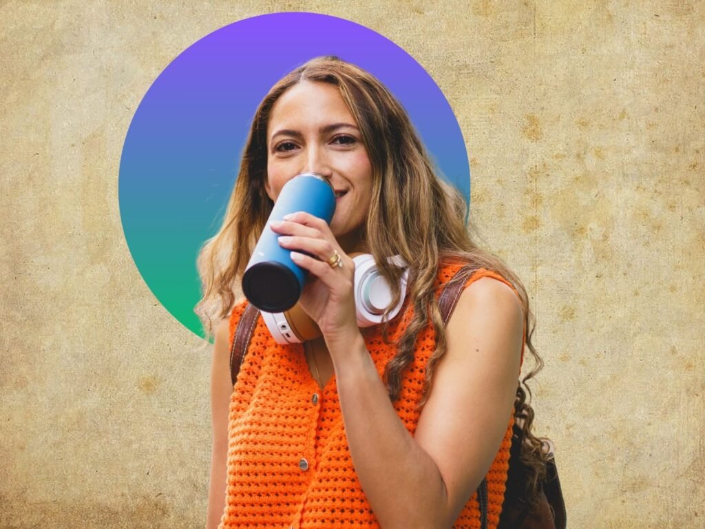 A woman drinking from reusable water bottle