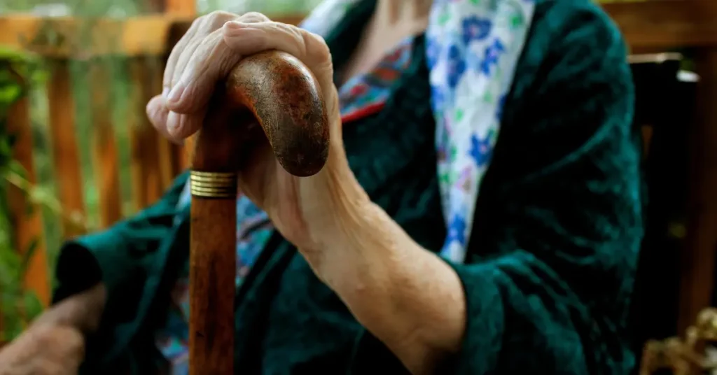 A caregiver assisting an elderly person in a calm and respectful home setting, reflecting quality elder care services in Dubai.