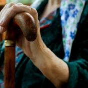 A caregiver assisting an elderly person in a calm and respectful home setting, reflecting quality elder care services in Dubai.