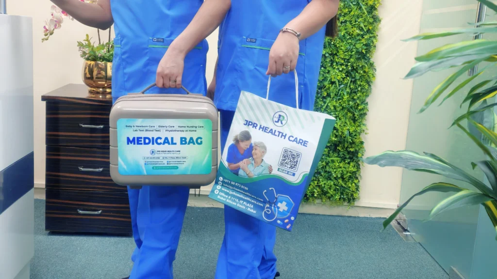 Two nurses from JPR Home Healthcare carrying medical bags for an elderly home care visit in Dubai.