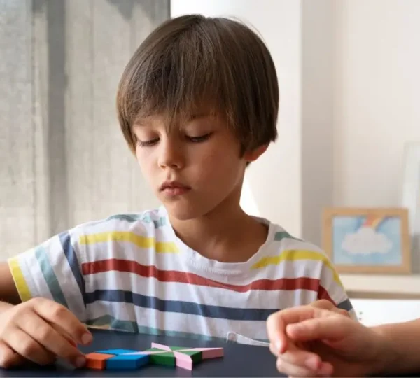 A home nurse is helping an autistic kid with activities