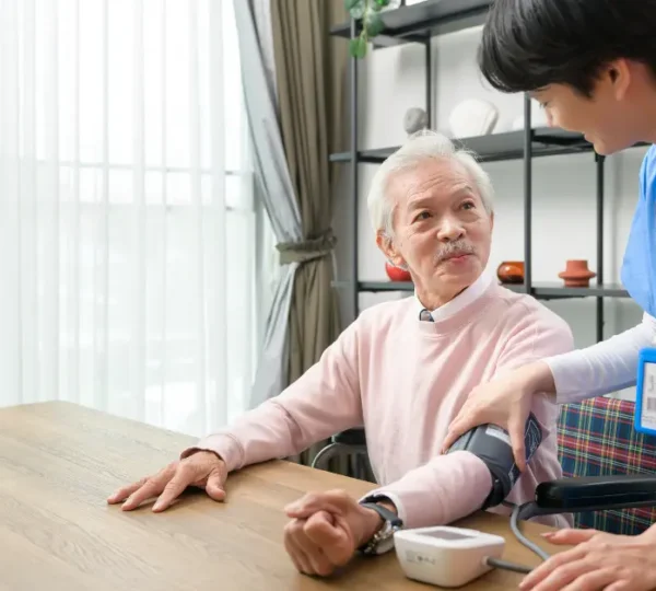 Nurse checking blood pressure of elderly
