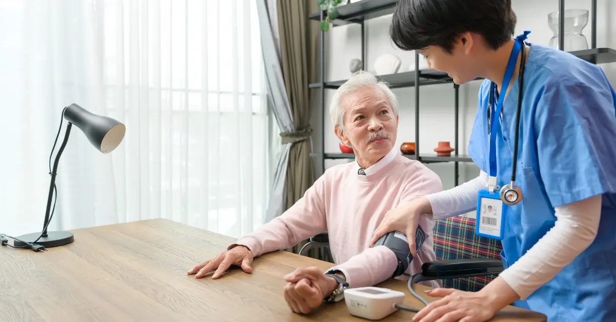 Nurse checking blood pressure of elderly